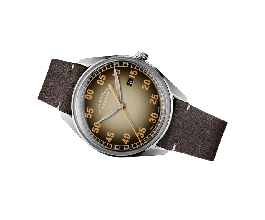 ELKA X09-0802, beige-to-black gradient dial with aged-lume numerals and date at 3, on brown cut-edge leather