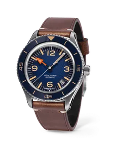 Undone Basecamp Classic Blue Date with blue dial and bezel, orange hour hand and date at 4:30 on a brown leather strap