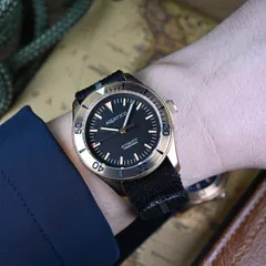 Aquatico Bronze Raider no-date with black dial and bronze bezel insert, on the wrist with a nylon strap