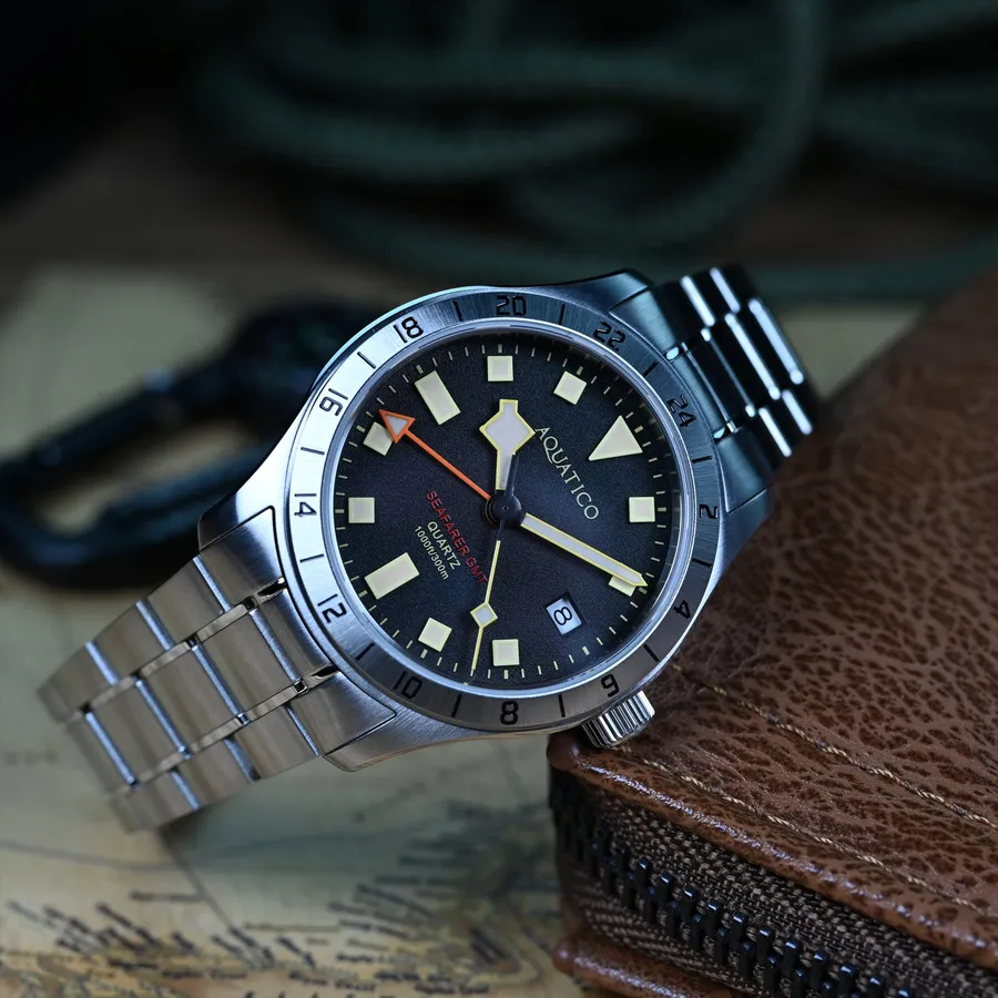 Aquatico Seafarer Quartz GMT with black dial, triangle and baton indices, steel 24-hour bezel and orange GMT hand, on steel bracelet