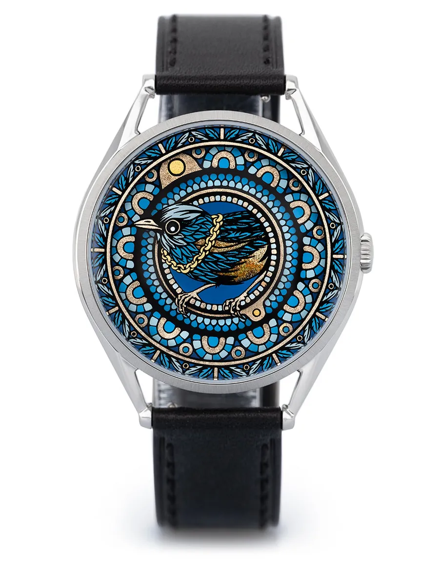 Mr Jones The Silent Thief, magpie inside concentric blue and gold patterned discs, steel case on black leather, front view