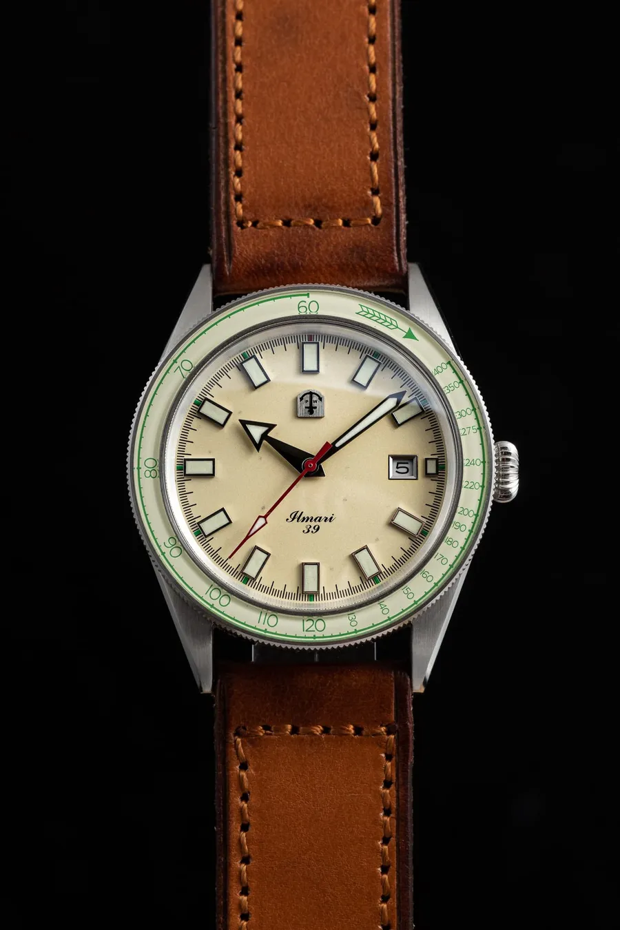 Pook Ilmari 39 with cream dial, green lume and lumed glass bezel on a brown leather strap