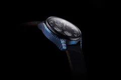 Zelos ZX-7 from the side, showing the layered Ti-Damascus case flank and lugs