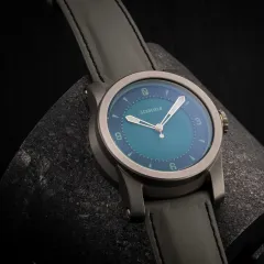 Schofield Strange Lights Not Quite Green on a grey strap
