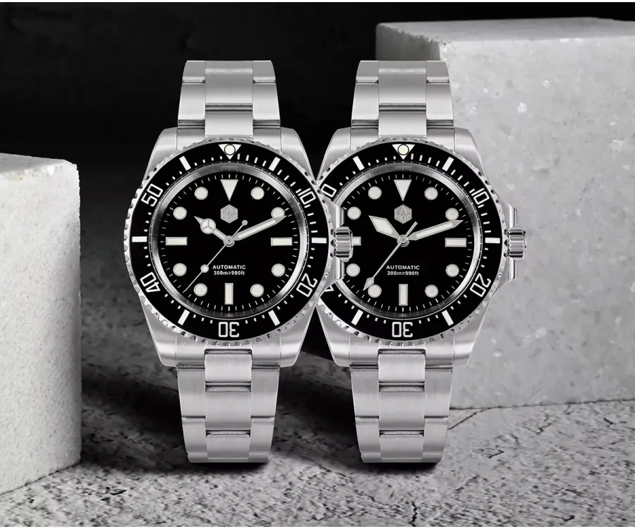 Two San Martin SN0111-G-A divers with black dials and black ceramic bezels on steel bracelets