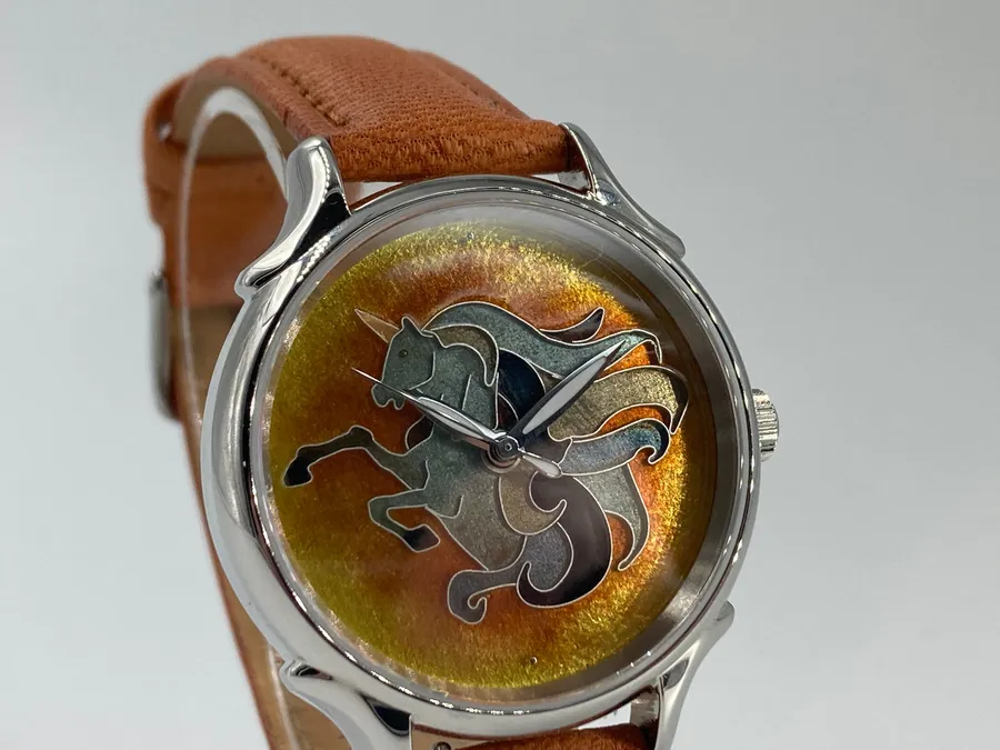 Cincinnati Watch Company Rising Star, cloisonné enamel unicorn on an orange and gold enamel dial, in a Celeste case on a tan leather strap
