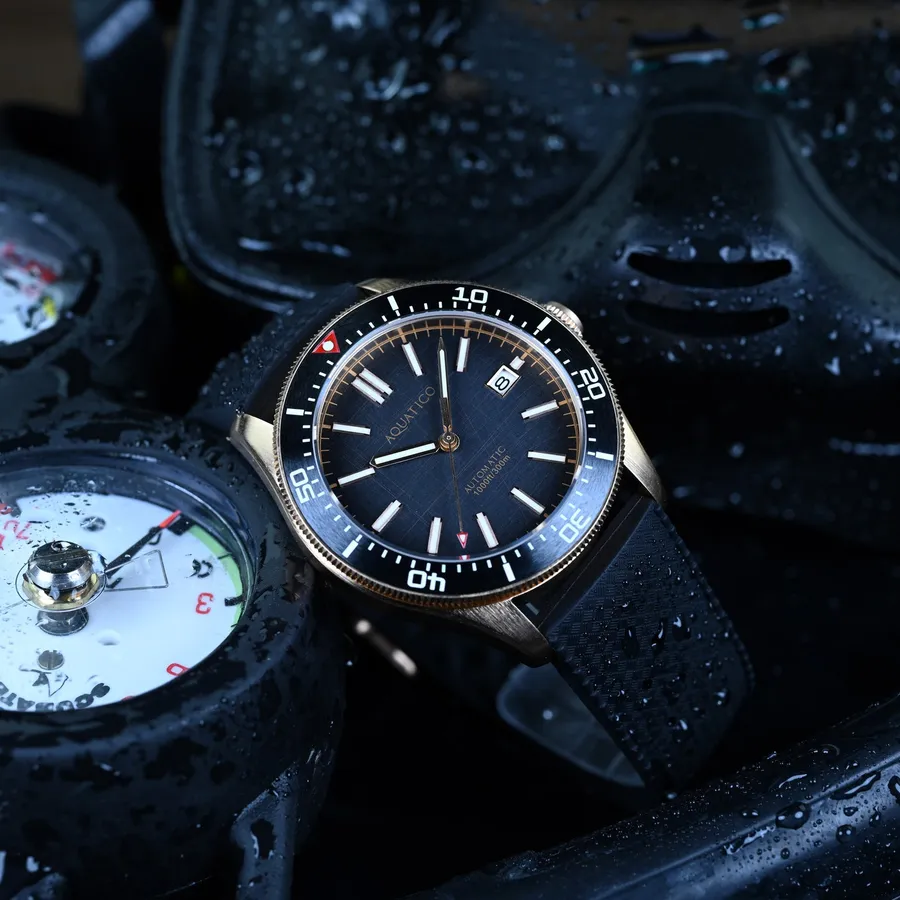Aquatico Bronze Star dive watch with black dial, black ceramic bezel and date at 3, on black rubber strap
