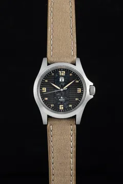 Pook Rokka with dark textured dial and tan Arabic numerals on a beige strap