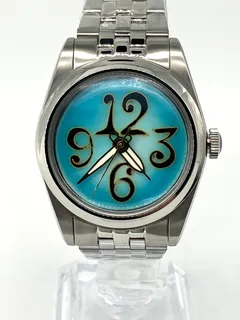 Cincinnati Watch Company The Numbers on Turquoise, oversized black 12, 3, 6 and 9 outlined in gold wire on a turquoise enamel dial, on a five-link bracelet