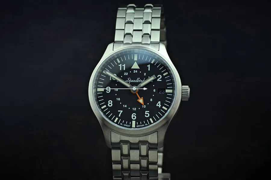 Timefactors Speedbird GMT PRS-22GMTQ, semi-matte black pilot dial with orange 24-hour hand and date at 3, on steel bracelet
