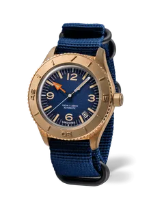 Undone Basecamp Classic Bronze Date with bronze case, blue dial, orange hour hand and date on a navy nylon strap