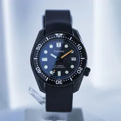 Thorn SHY019 in a black case with woven-pattern dark dial and black bezel on a black rubber strap