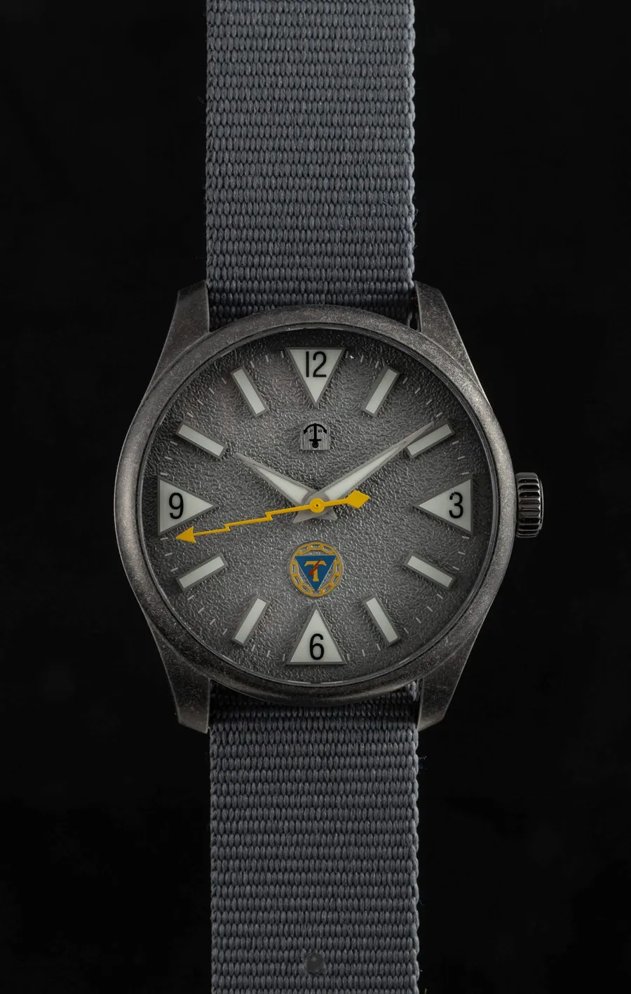 Pook Osasto Törni with textured grey dial and aged steel case on a grey nylon strap