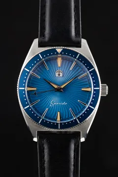 Pook Saaristo with blue sunburst dial and blue glass bezel on a black leather strap