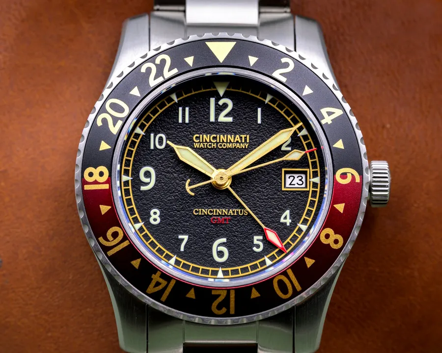 Cincinnati Watch Company Cincinnatus GMT, black grained dial with date at 3, black and red aluminium 24-hour bezel, on steel bracelet