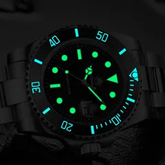 Addiesdive H3QZ in the dark, markers and hands glowing green and the bezel scale glowing blue