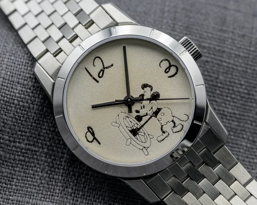 Cincinnati Watch Company Riverboat Rodent featuring Steamboat Willie, black enamel Steamboat Willie image and numerals on a sablage silver dial, on a seven-link steel bracelet