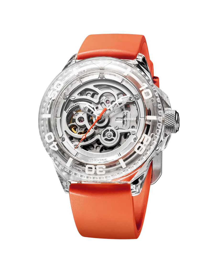 Undone Aquadeep K9 Crystal Silver with transparent crystal case and skeleton dial on an orange strap