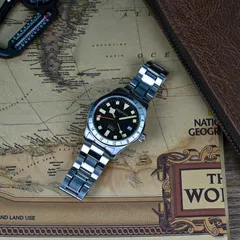 Aquatico Seafarer Quartz GMT on steel bracelet, lying on a map
