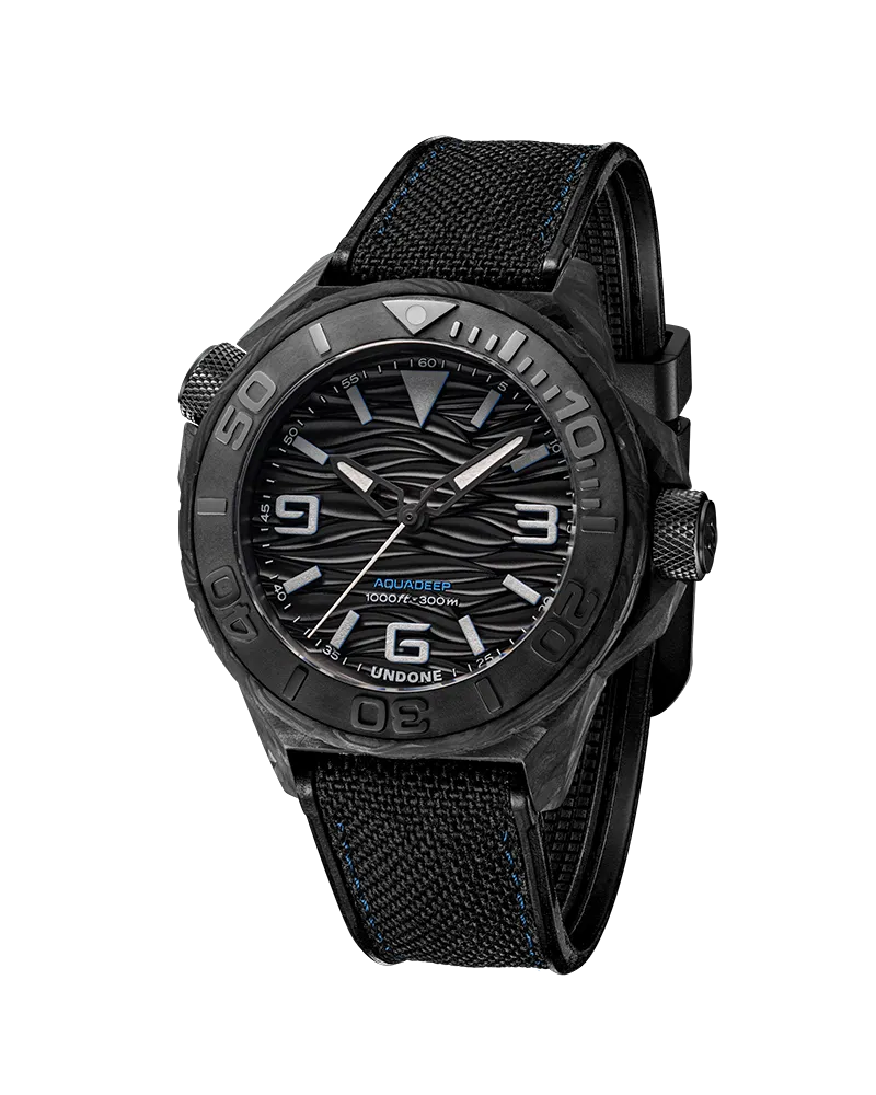 Undone Aqua Carbon Maggy with forged carbon case and black wave dial on a black fabric strap
