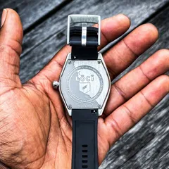 Lōcī Pacific Coast Highway caseback with engraved artwork, held in hand