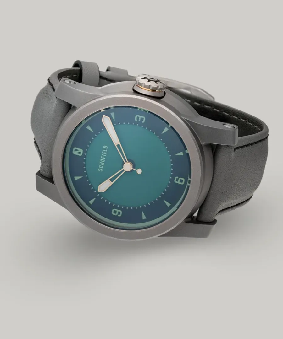 Schofield Strange Lights Not Quite Green in titanium with a green dial on a grey strap
