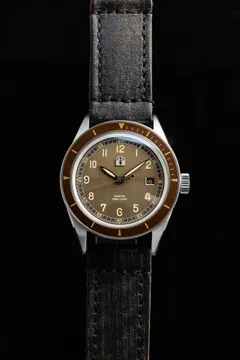 Pook Kontio with brown textured dial and brown bezel on a dark strap
