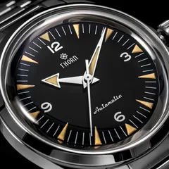 Close-up of the Thorn T026A black dial with Arabic numerals and arrow hands