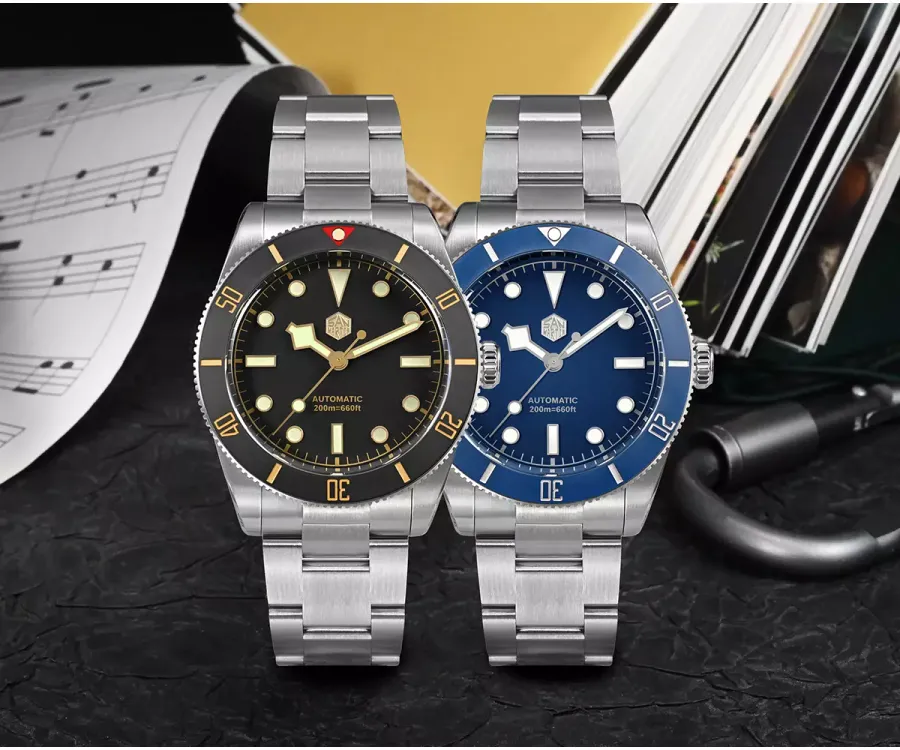 San Martin SN0138-G divers with matte black dial and gilt accents and matte blue dial, with black and blue ceramic bezels on three-link bracelets