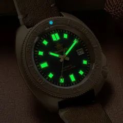 Addiesdive AD2104 lume shot, dial glowing green and the bezel pip blue