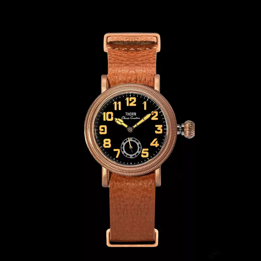 Thorn T013 in tin bronze with black dial, orange numerals and small seconds on a tan leather strap