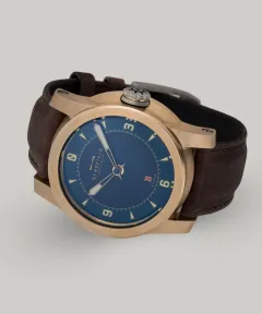 Schofield B3 in raw bronze with a blue dial on a brown strap