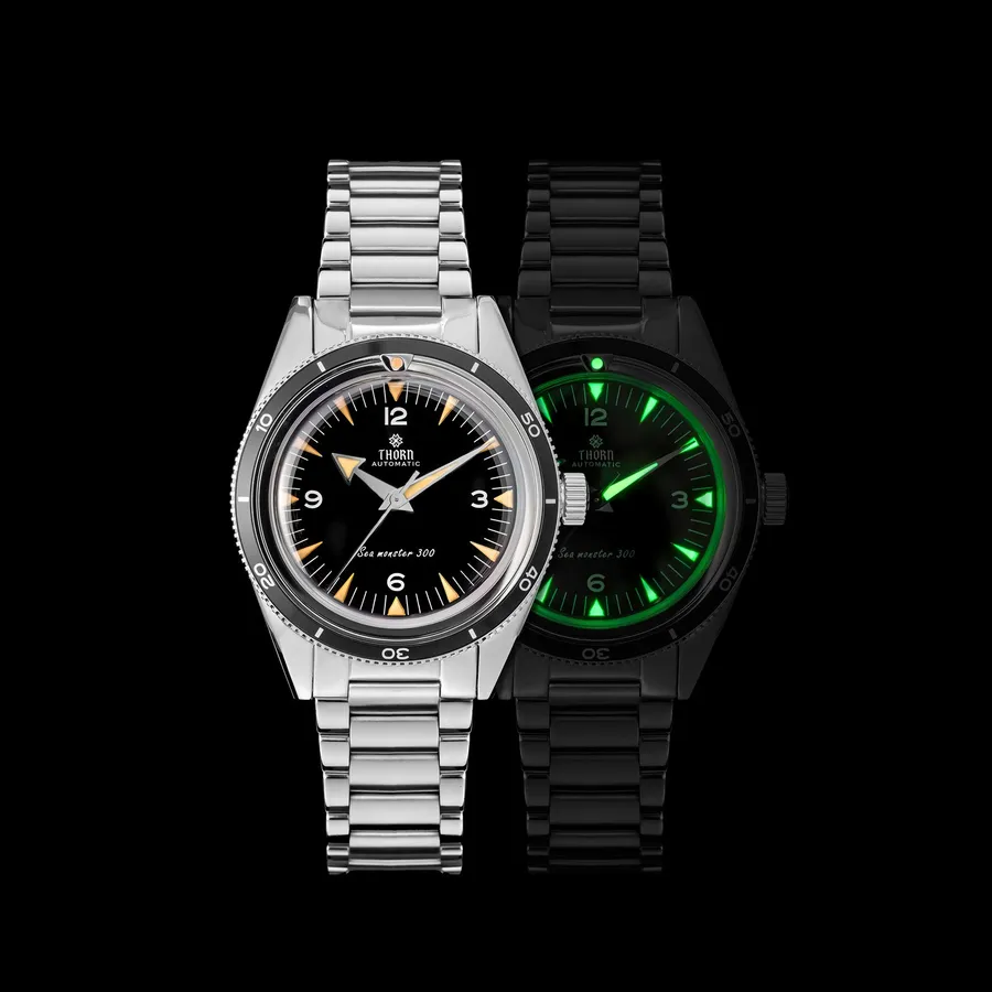Thorn T026B Seamaster 300-style diver with black dial and black bezel on the steel bracelet, beside a lume shot