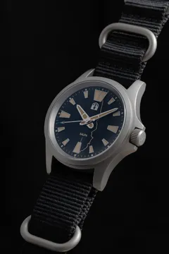 Pook Salpa with a dark blue-black dial seen at an angle on a black nylon strap