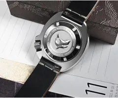 Screw-down caseback of the San Martin SN047-B-Q with pressed shark