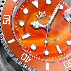 AddiesKIN K012 close-up of the orange sardonyx stone dial, faceted indices and date cyclops