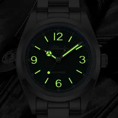 Addiesdive AD2518 lume shot of the green dial, with green-glowing numerals, markers and hands