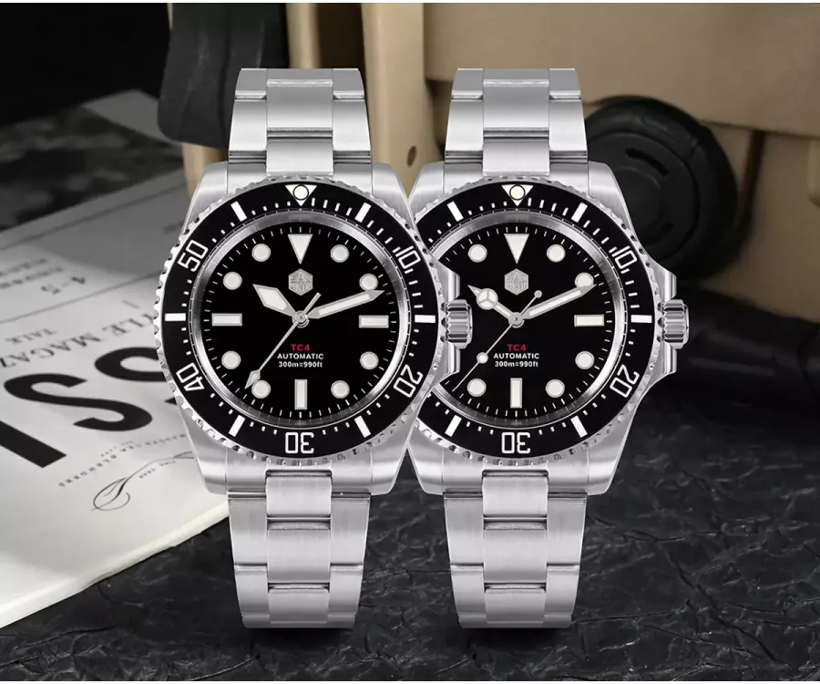 Two San Martin SN0111-T-A1 Grade 5 titanium divers with black dials and black ceramic bezels