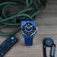 Aquatico Steel Man GMT with blue sunray numeral dial and blue and black bezel, on blue rubber strap