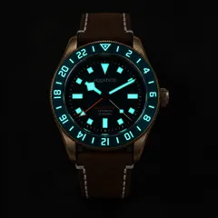 Aquatico Bronze Seafarer GMT lume shot (dial, hands and bezel)